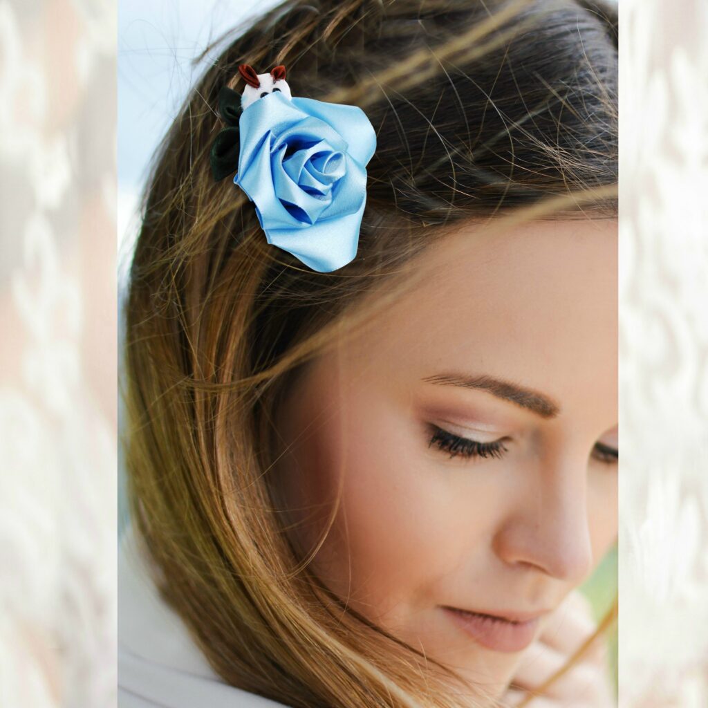 a woman wearing light blue rose and bunny hair clip