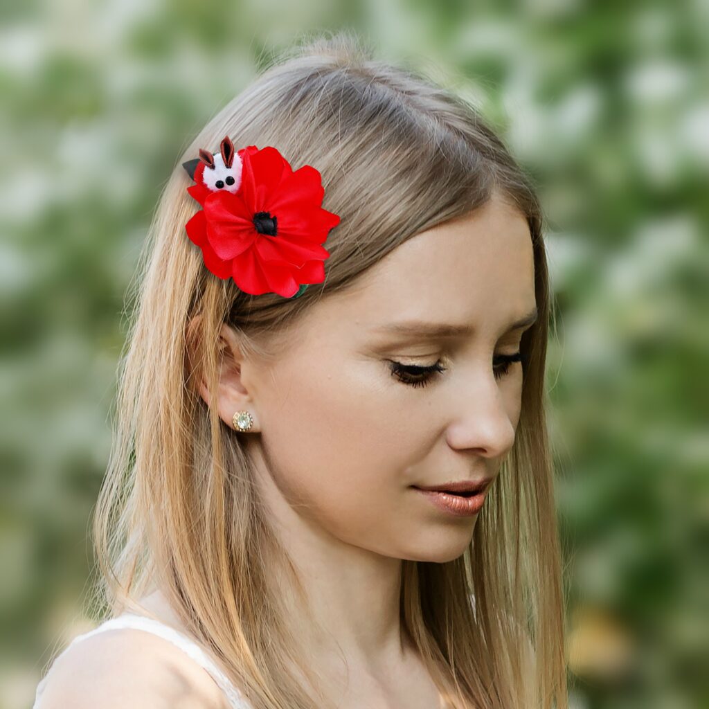 a woman wearing red poppy hair clip