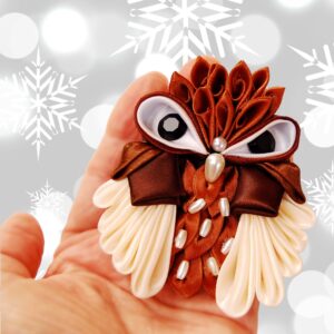 owl brooch in a hand