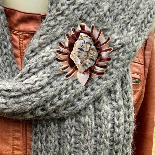 a fabric brooch on a scarf