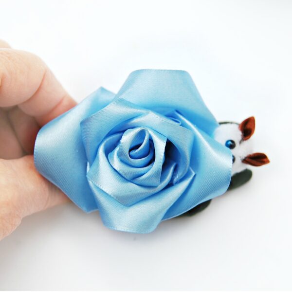 a hand holding blue hair clip