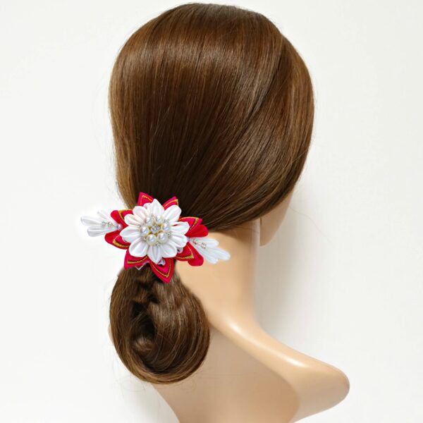 a model with a red white hair clip