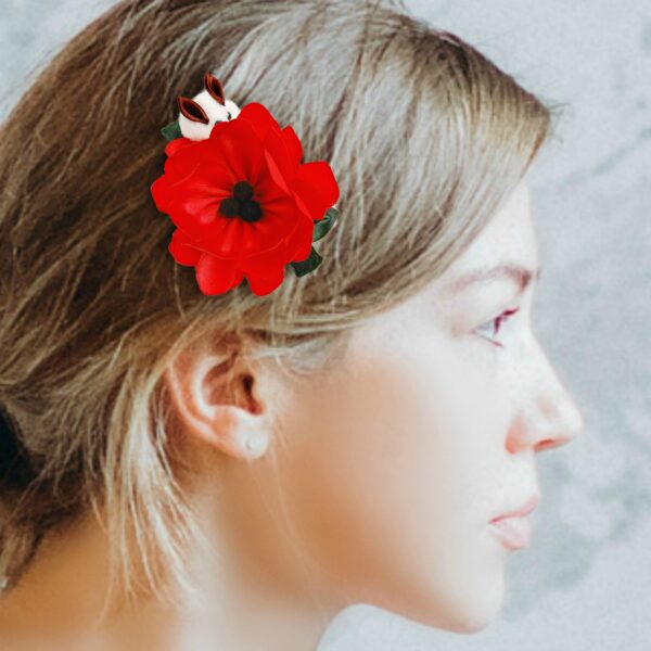 a woman wearing a poppy hair clip