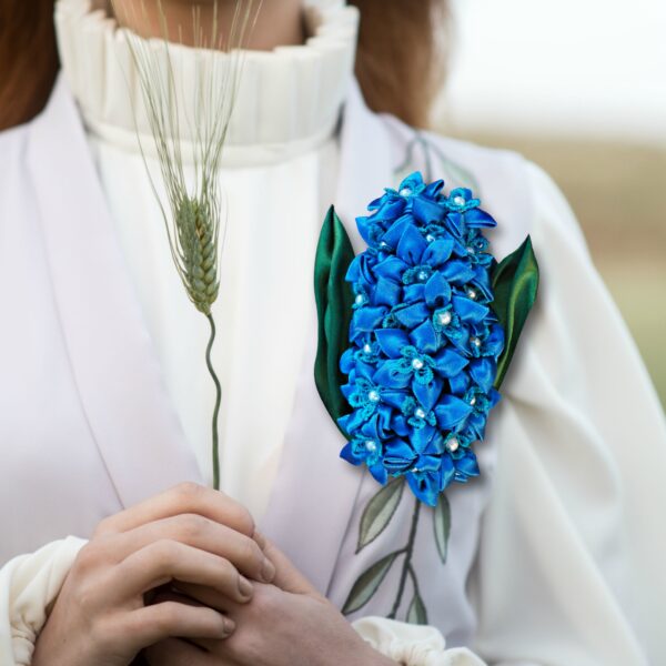 a woman with a blue brooch