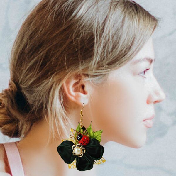 a woman with clover and ladybug earrings