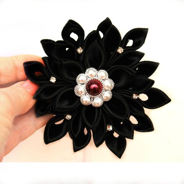 black hair clip in a hand