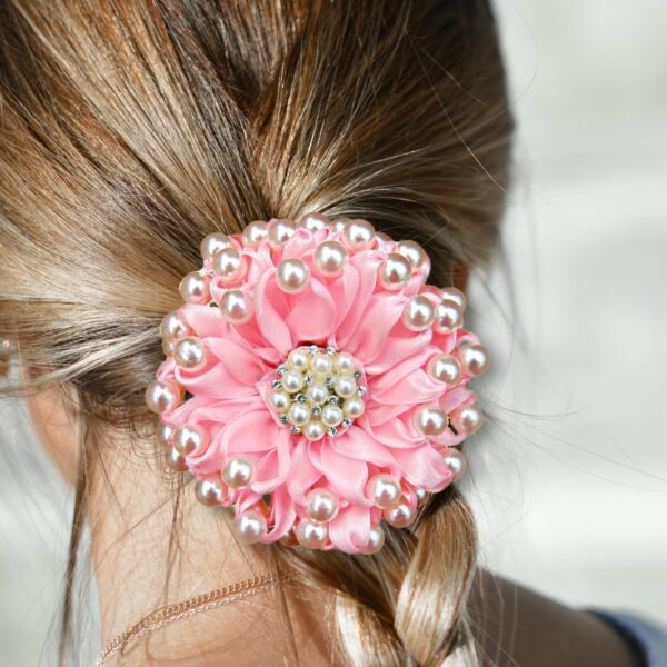 a girl wearing pink beaded hair bow