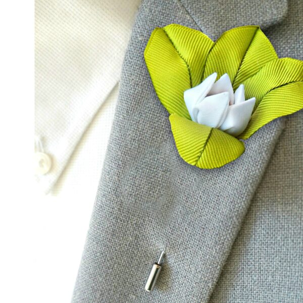 a man wearing lily lapel pin