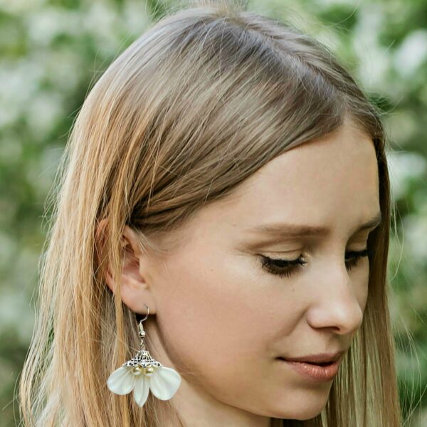 a woman wearing dangle fabric earrings