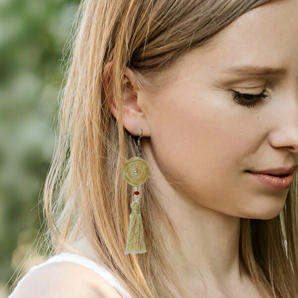 a woman wearing ivory tassel earrings