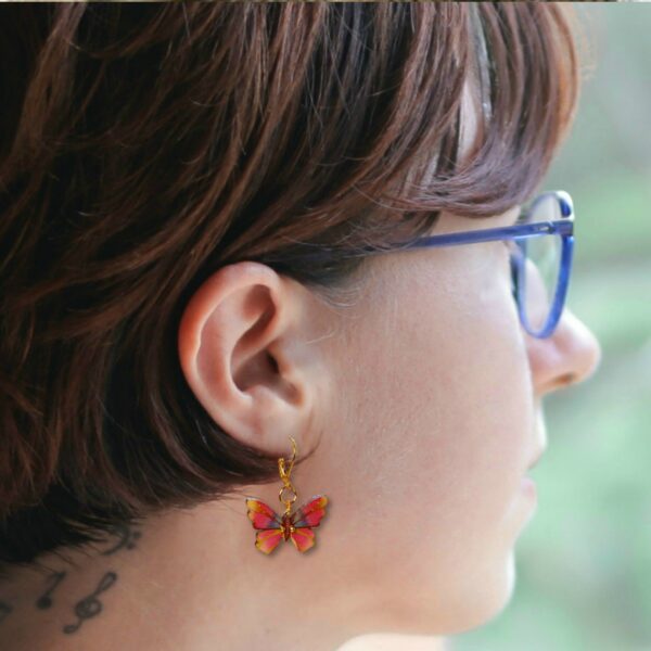 a young woman with butterfly earrings