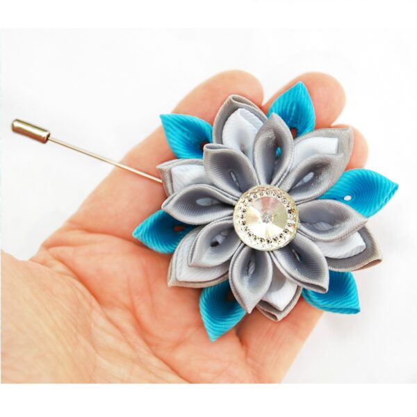 blue gray lapel pin in a hand