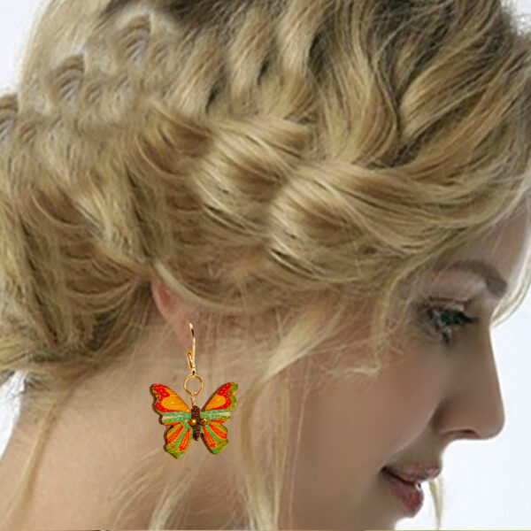 a woman wearing butterfly earrings