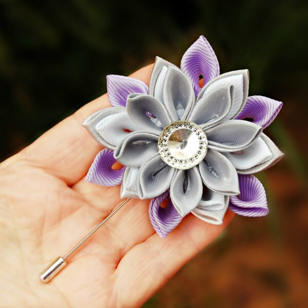 lilac gray lapel brooch in a hand