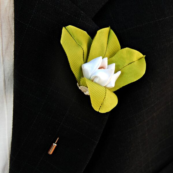 lily lapel pin on a jacket