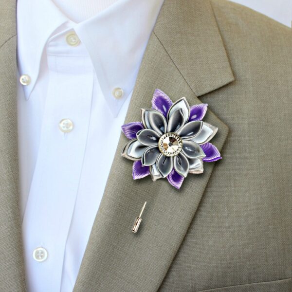 man wearing lilac flower lapel pin