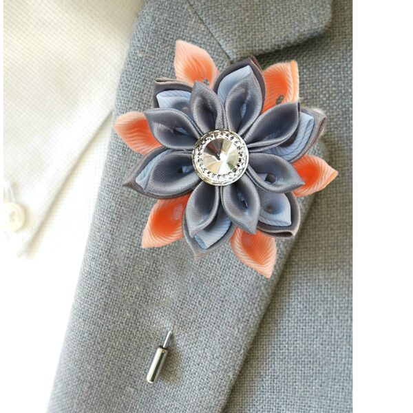 man wearing peach lapel pin