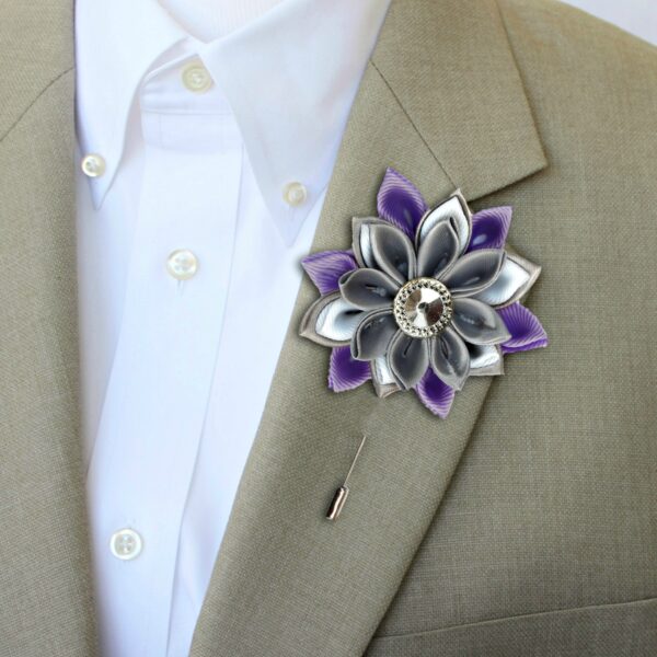 man wearing lilac flower lapel pin