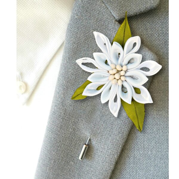 white lapel pin on a suit