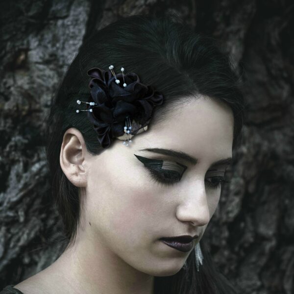 A gothic woman wearing a black flower