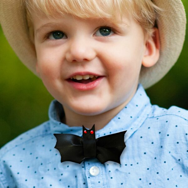 a boy wearing a bat bowtie