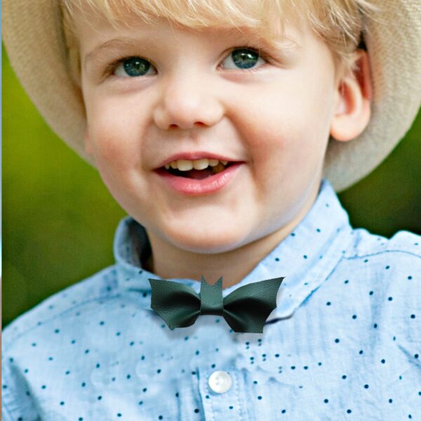 a boy wearing a green bat bow tie