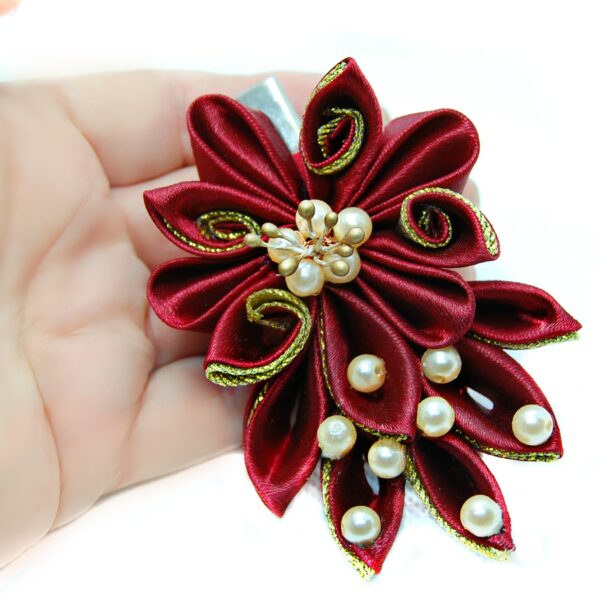 a burgundy hair clip in a hand