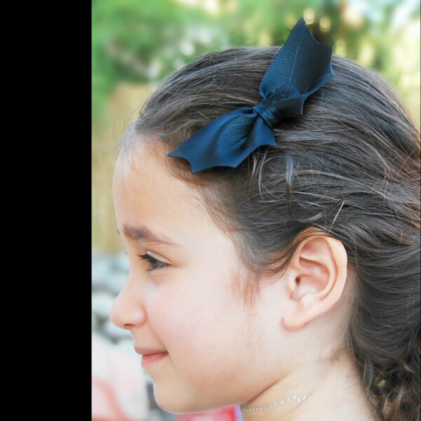 a girl wearing a small bat bow