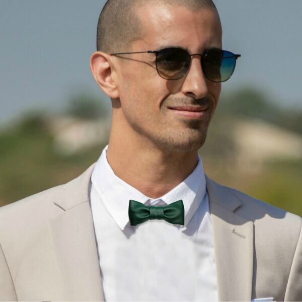 a man wearing emerald green bow tie