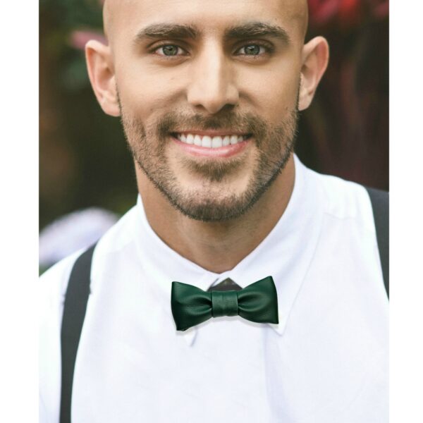 a man wearing green faux leather bow tie