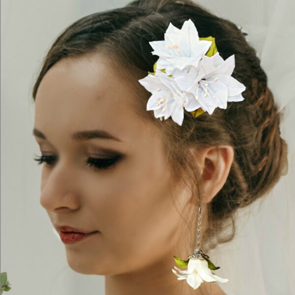 a woman wearing a hair clip and earrings