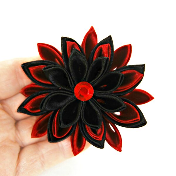 black red Kanzashi flower in a hand