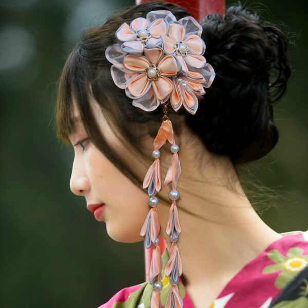 Japanese woman in kimono wearing peach flower hairpiece