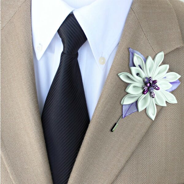 a groom wearing white lilac boutonniere