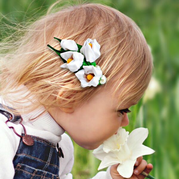 a toddler wearing lily flower hair clip