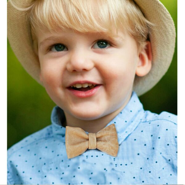 a boy wearing a light brown bow tie