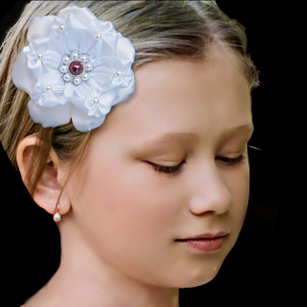 a girl wearing white flower hair clip