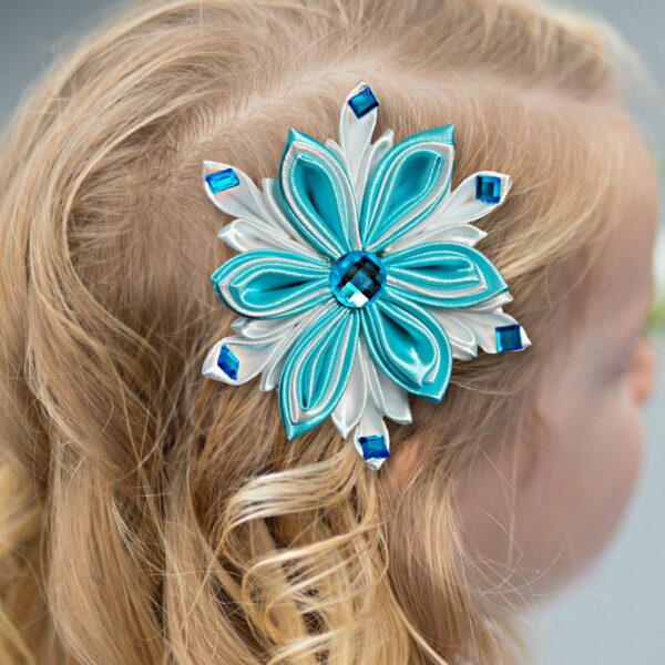 a girl wearing a snowflake hair clip