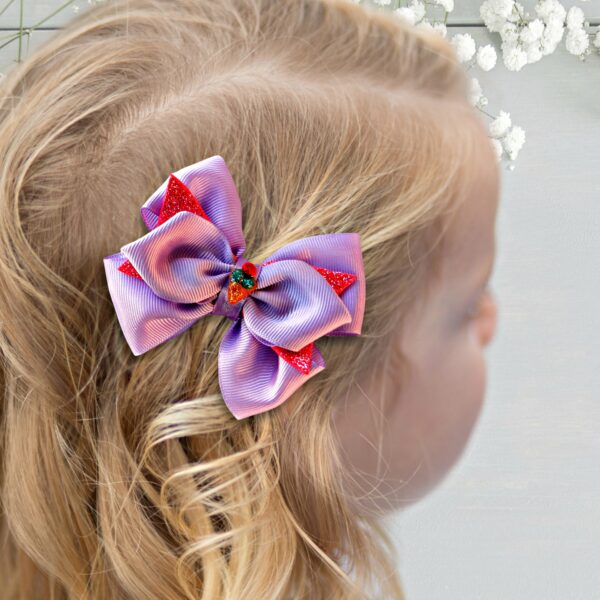 a girl wearing purple hair bow