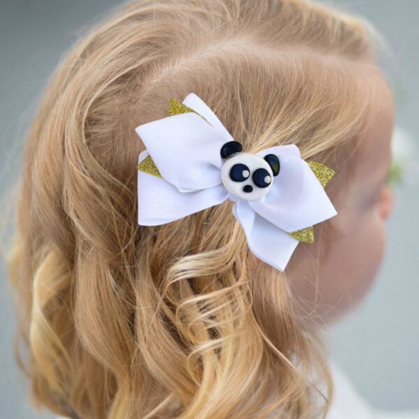 a girl wearing white gold panda hair clip