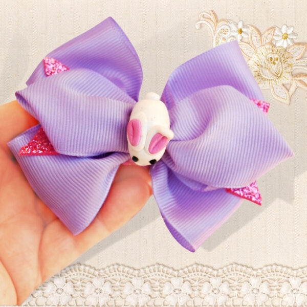 purple hair bow decorated with white bunny