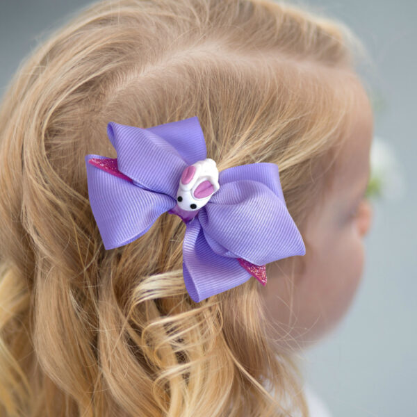 a girl wearing purple hair clip with bunny