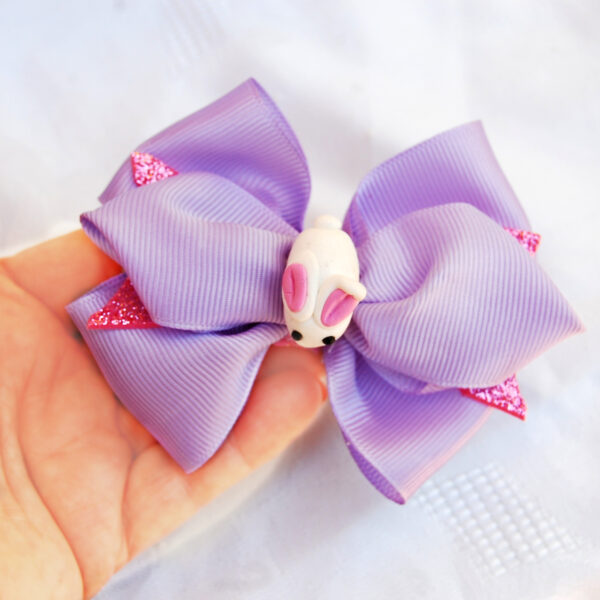 violet hair clip decorated with white bunny