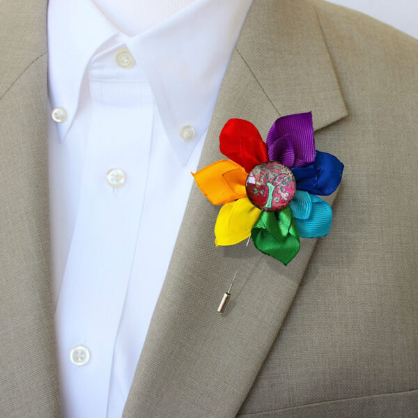 a man wearing a rainbow pin