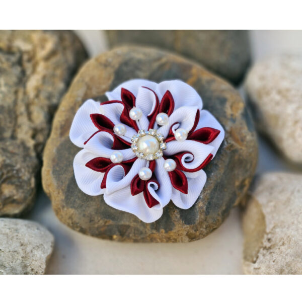 white maroon brooch