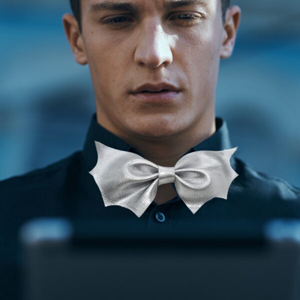 man wearing silver bat bow tie